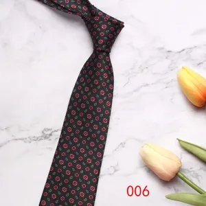 Detailed close-up of dark green men's business tie with retro paisley pattern on marble.