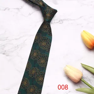 Close-up detail of dark green men necktie with gold floral pattern on marble background