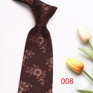 Close-up view of a dark brown mens tie featuring a floral jacquard pattern, elegant detail.