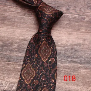 Classic paisley pattern men tie detail view, elegant vintage black fabric design for formal suit.