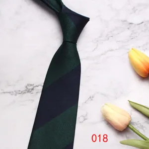 Detailed view of the dark green and navy striped business men's tie on marble background.