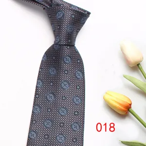 Close-up detail of the men's business patterned tie featuring elegant weave and tulip prop decor.