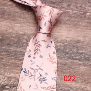 Detail view of pink floral necktie with delicate leaf patterns, fine fabric texture.