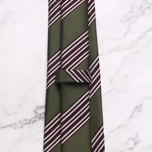 Green striped business men tie detail view, elegant retro style professional necktie accessory.