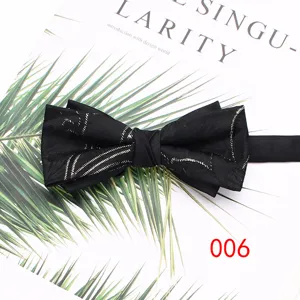 Vista detallada de una pajarita negra de poliéster con patrón plateado, ideal para bodas y eventos.