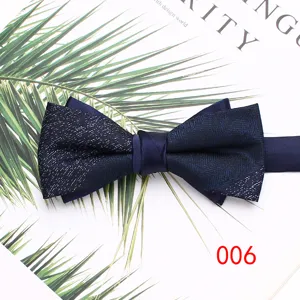 Detail view of a stylish navy blue double layer bow tie with glitter fabric and satin knot.