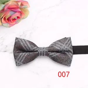 Detailed view of a stylish plaid bow tie with textured fabric and classic British pattern.