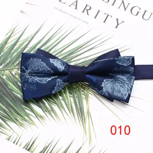 Detailed view of the dark blue floral printed mens bow tie, elegant accessory.