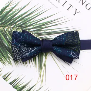 Men's blue double layer bow tie with elegant floral embroidery for wedding tuxedo suit.