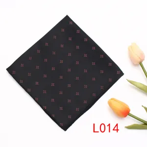Vista detallada de un pañuelo de bolsillo negro con un delicado patrón floral rojo y costuras.