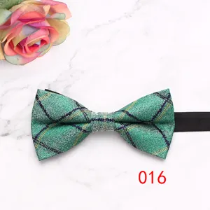 Green plaid bow tie detail shot, classic British style fabric with elegant grid pattern and strap.
