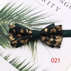 Detailed closeup of a luxurious double-layer men's green and gold leaf pattern bow tie.