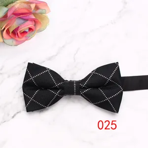 Classic black grid bow tie detail, elegant mens suit accessory for business and wedding.