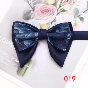 Detail view of dark blue layered floral bow tie showing exquisite texture and elegant style.
