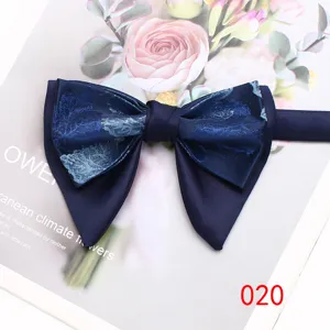 Detailed view of a stylish navy blue double-layer bow tie with elegant floral pattern.