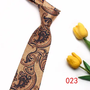 Detailed close-up view of the elegant golden paisley patterned tie with classic herringbone texture.