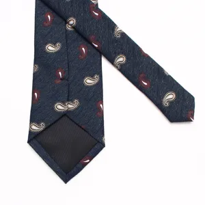 Detailed view of dark blue paisley patterned tie, classic British style accessory for men.