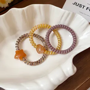 Cute phone cord hair ties set featuring plaid star pendants and stylish designs for daily wear.