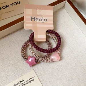 Telephone wire hair ties set with cute heart and star charms, fashionable hair accessories for women.