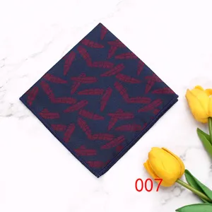 Detailed shot of a stylish dark blue pocket square featuring an elegant red feather print pattern.