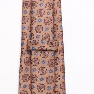 Detailed close-up view of men's brown floral pattern woven formal business necktie.