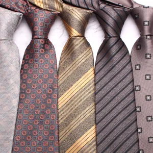 Detail view of men's business casual neckties featuring classic floral and stripe patterns.