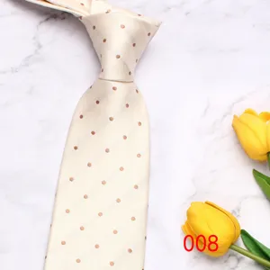 Close-up detail shot of a classic men's polka dot tie with textured chevron pattern.