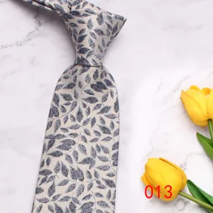Classic men's silk tie with elegant blue leaf pattern, stylish accessory for business and casual wear.