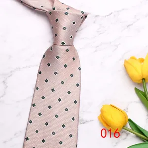 Detailed view of pink men's business casual tie with dark diamond pattern and marble background.