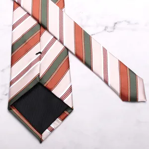 Detail view of men's classic striped silk tie in elegant orange and green colorway.