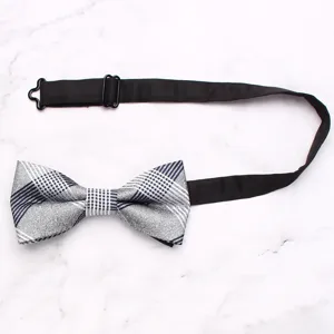 Detailed view of a classic black and white plaid men's bow tie with adjustable strap.