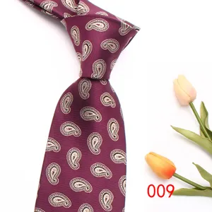 Detailed close-up of a stylish burgundy men's paisley silk tie with floral pattern.