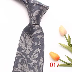 Detailed close-up view of a stylish grey men's tie featuring an elegant silver floral jacquard.