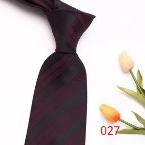 Classic men's striped tie detail showing rich burgundy color and elegant diagonal texture weave.