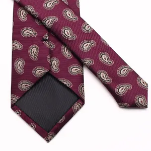 Close-up detail of a burgundy men's paisley necktie, premium silky textured fabric.