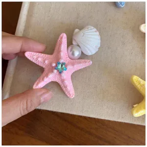 Close-up of a sweet ocean-style resin starfish hairpin detail, featuring pearl and blue crystal.