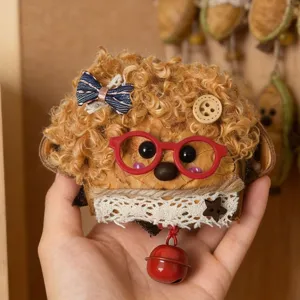 Close-up detail of cute handmade nut shell doll pendant with curly hair and glasses.