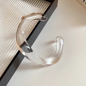 Clear acrylic irregular geometric open cuff bracelet minimalist fashion jewelry detail.