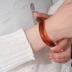 Amber acrylic irregular open bracelet detail shot, chic minimalist geometric hand jewelry for women.