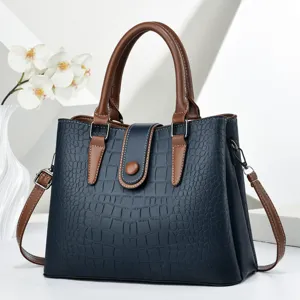Vintage dunkelblaue Handtasche mit Krokodilprägung und braunen Griffen
