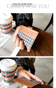 Detailed close-up of slim card holder showing fine stitching and houndstooth pattern.