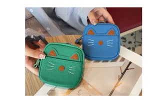 Cute mini cat leather coin purse with zipper and keychain, ideal for compact everyday storage.