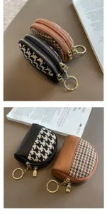 Detailed view of the stylish houndstooth double zipper coin purse with handy key ring.
