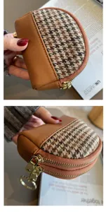 Detailed close-up view of the dual-zipper houndstooth coin purse with keyring and PU leather.