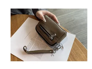 Mini leather coin purse with double zipper and wrist strap, compact design in khaki brown.