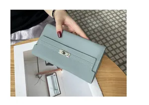 Genuine leather long wallet for women, elegant sage green design with metal lock closure.
