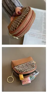 Stylish houndstooth fabric coin purse with double zippers, brown leather trim, and handy key ring.
