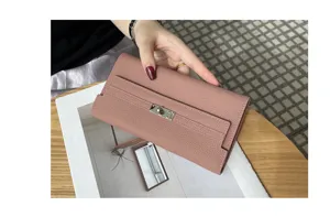 Pink leather long wallet detail, elegant strap and turnlock closure, premium genuine leather.
