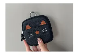 Cute black leather cat coin purse with zipper closure, metal ring and embroidered details.