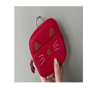 Red leather cat coin purse detail view, cute zipper pouch, compact keychain accessory.